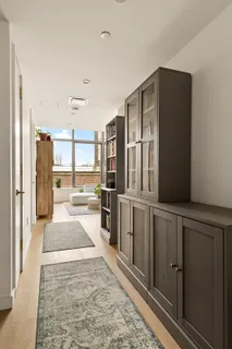 a view of a kitchen with refrigerator and windows