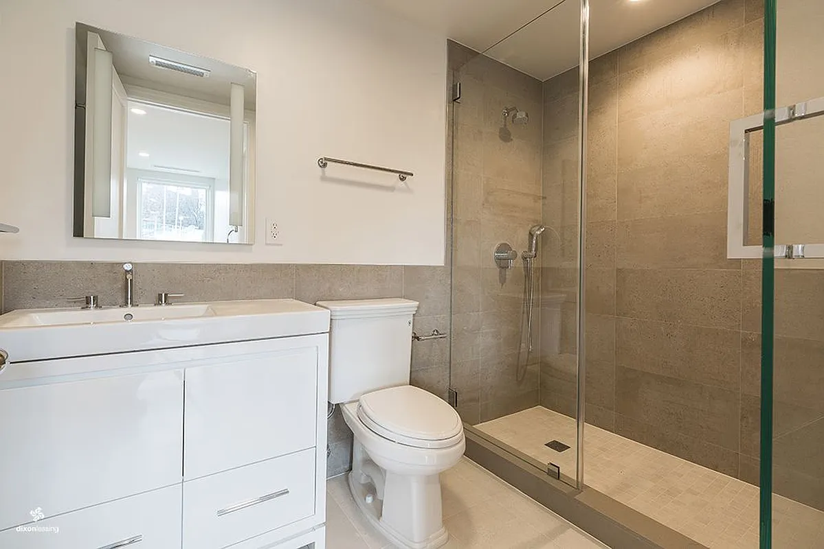 2001 5th Avenue, Unit 2 Manhattan, NY 10035 - Photo 4 of 9 a bathroom with a sink toilet and shower