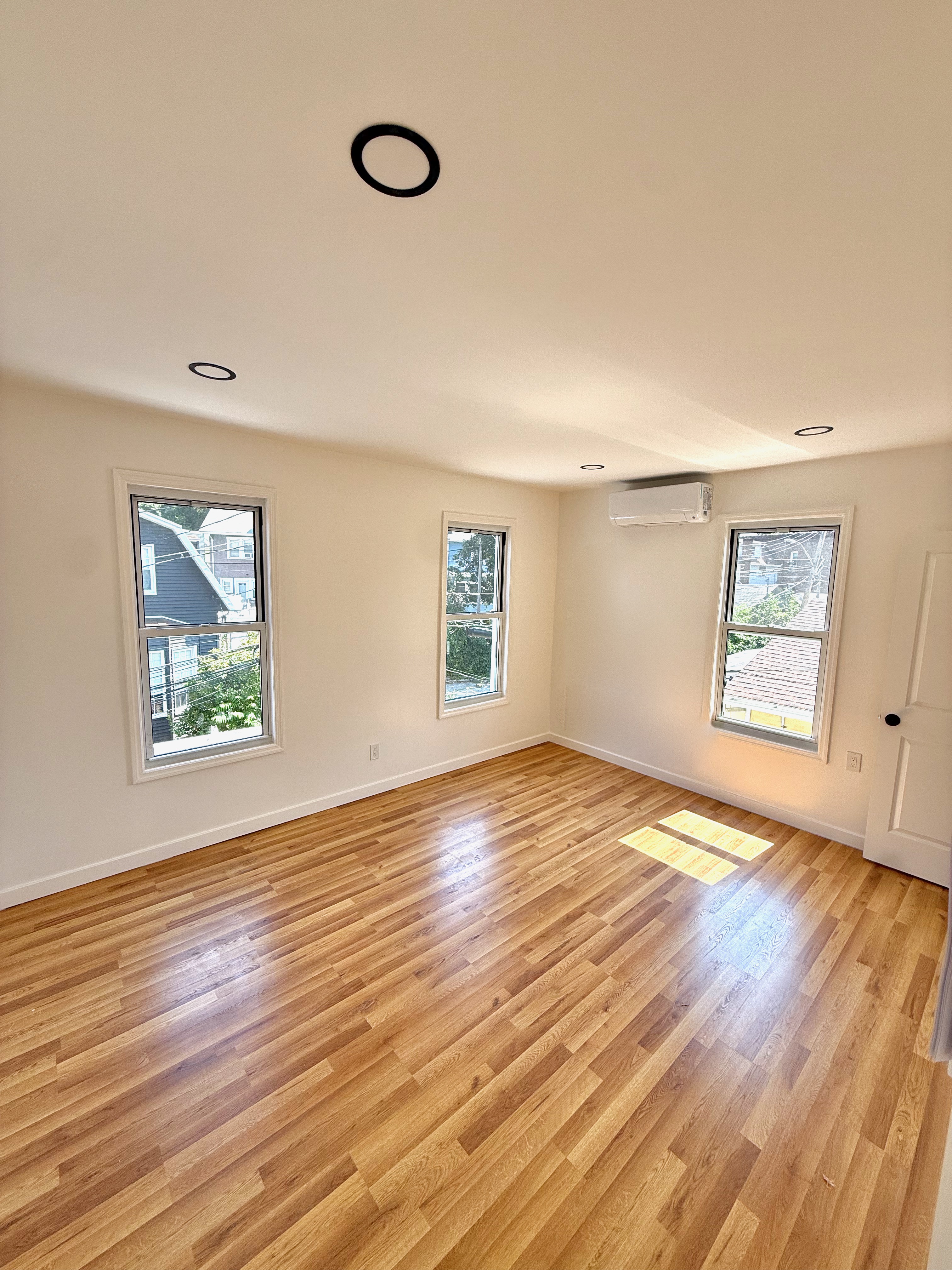 14 Vermont Court, Unit F Brooklyn, NY 11207 - Photo 8 of 10 a view of empty room with wooden floor and fan
