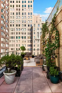 a view of a patio with couches and potted plants