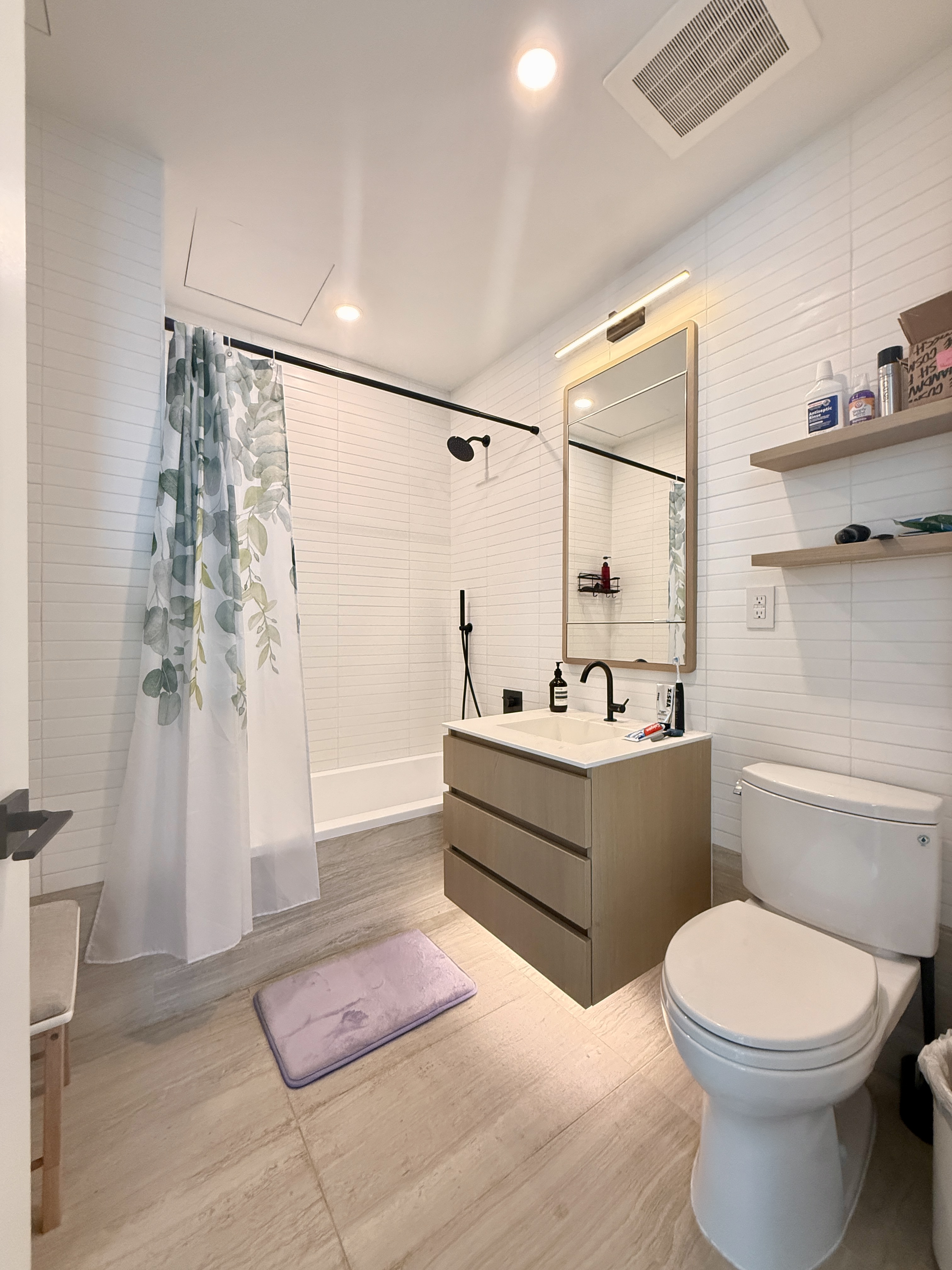 4507 Court Square, Unit 8D Queens, NY 11101 - Photo 12 of 28 a bathroom with a sink a toilet and shower