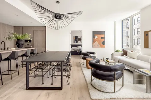 a living room with furniture a window and a chandelier