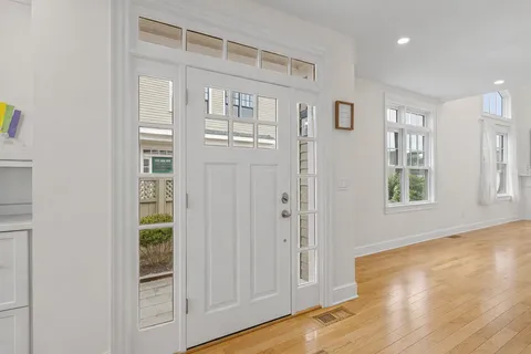 a view of front door with wooden floor
