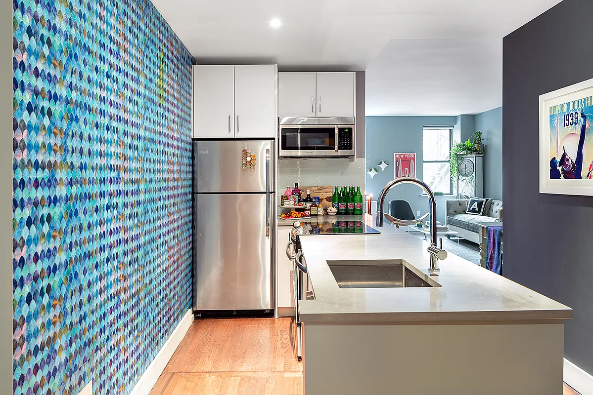 245 West 25th Street, Unit 3S Manhattan, NY 10001 - Photo 2 of 13 a kitchen with stainless steel appliances a refrigerator sink and microwave