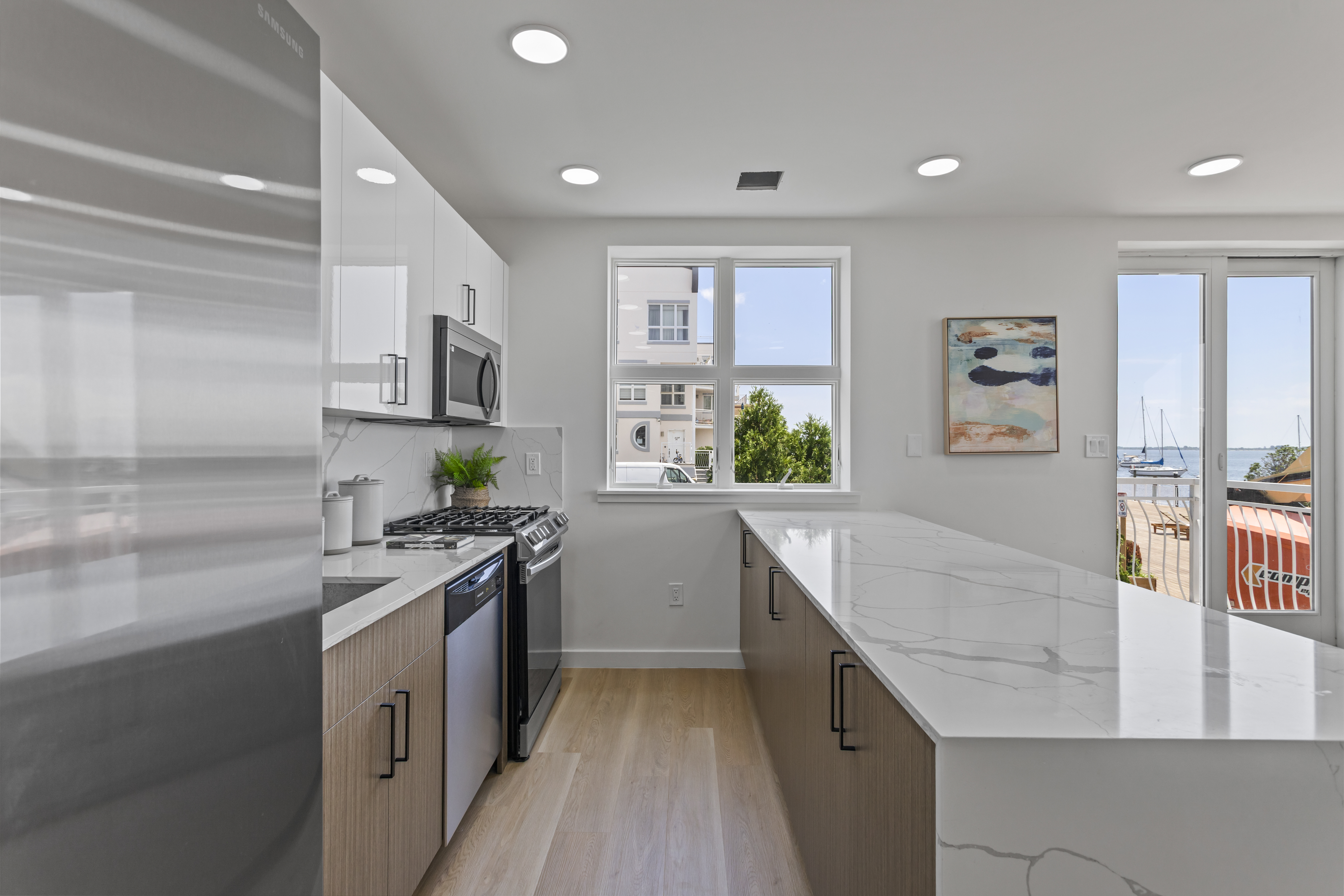 3112 Emmons Avenue, Unit 3124A2 Brooklyn, NY 11235 - Photo 4 of 17 a kitchen with stainless steel appliances granite countertop a sink stove and refrigerator