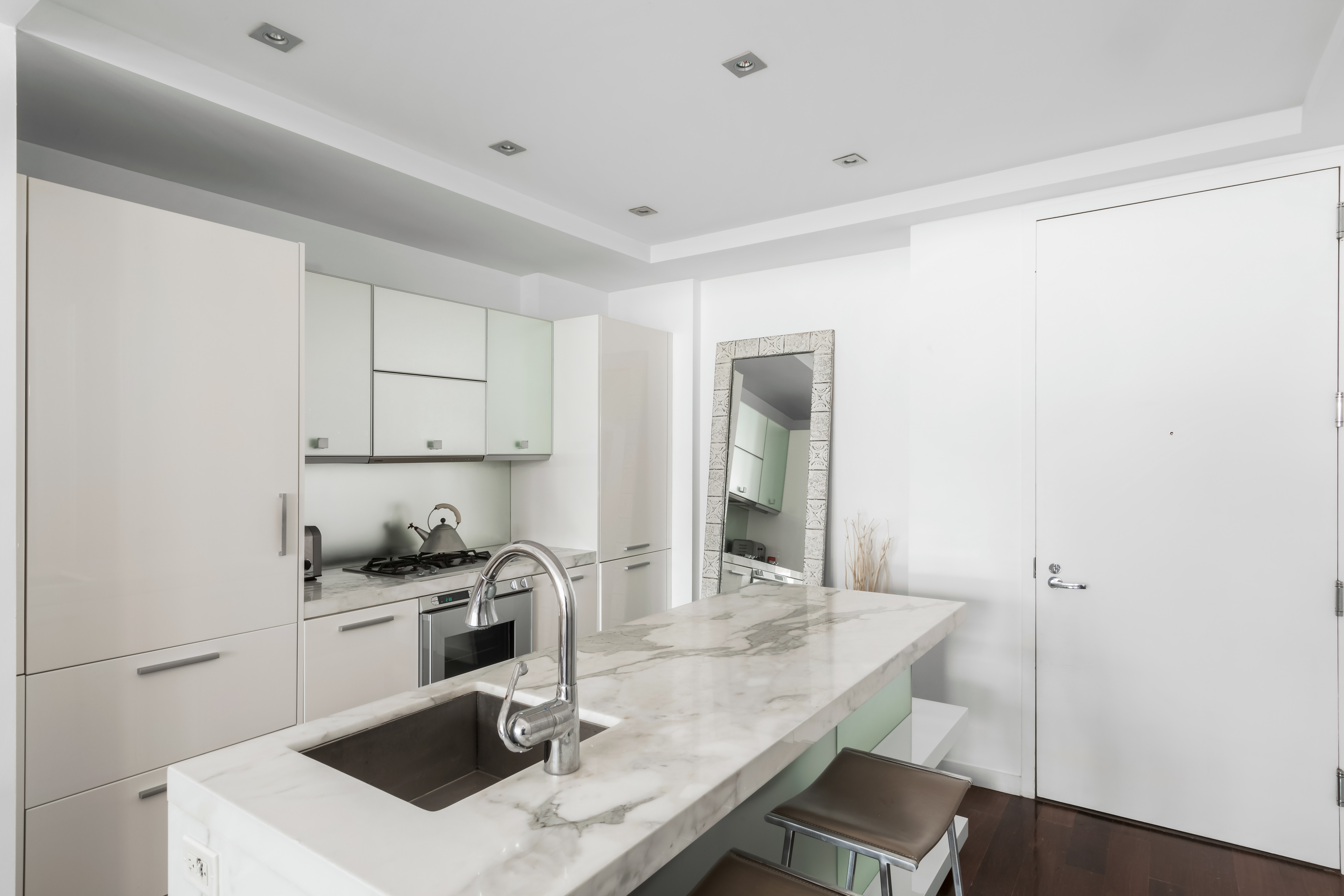 444 West 19th Street, Unit 403 Manhattan, NY 10011 - Photo 3 of 6 a kitchen with a sink a stove and cabinets