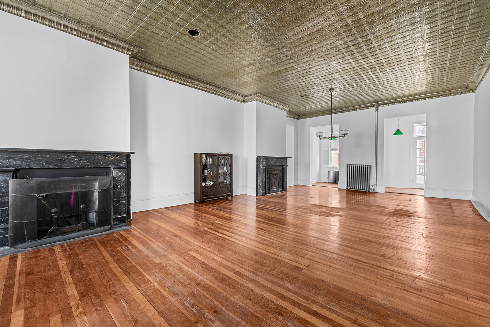 44 Butler Street Brooklyn, NY 11231 - Photo 3 of 22 a view of empty room with wooden floor and fireplace