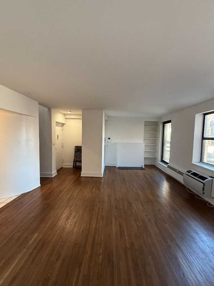 455 Park Avenue South, Unit PH1 Manhattan, NY 10016 - Photo 3 of 17 a view of empty room with wooden floor and window