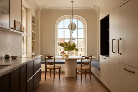 a view of a a dining room with furniture window and wooden floor