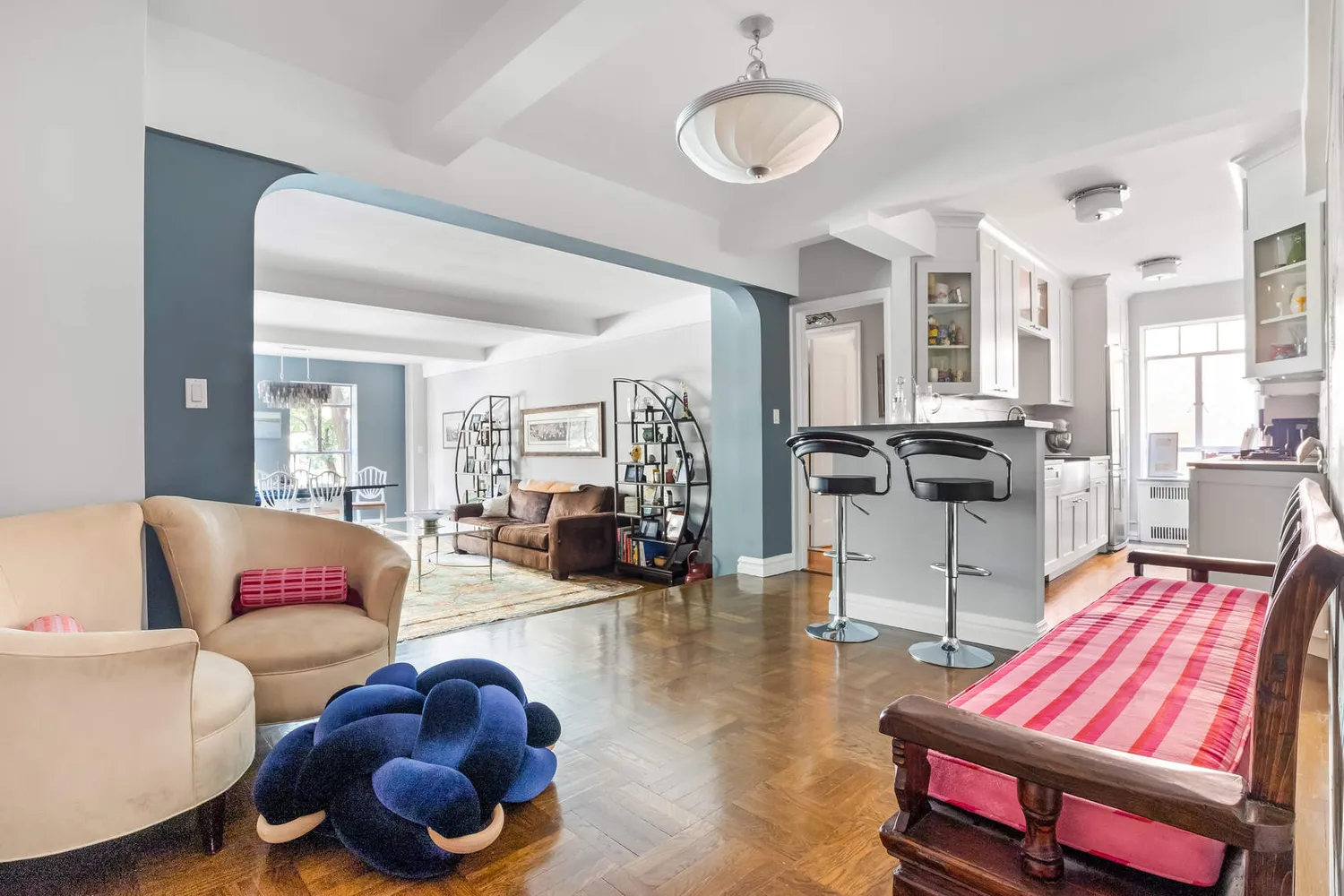 a living room filled with furniture and a chandelier