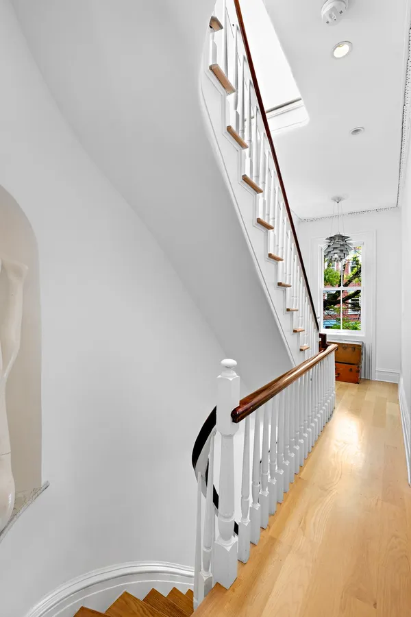a bedroom with a bed large window with table and chair