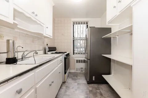 a kitchen with a sink and a refrigerator
