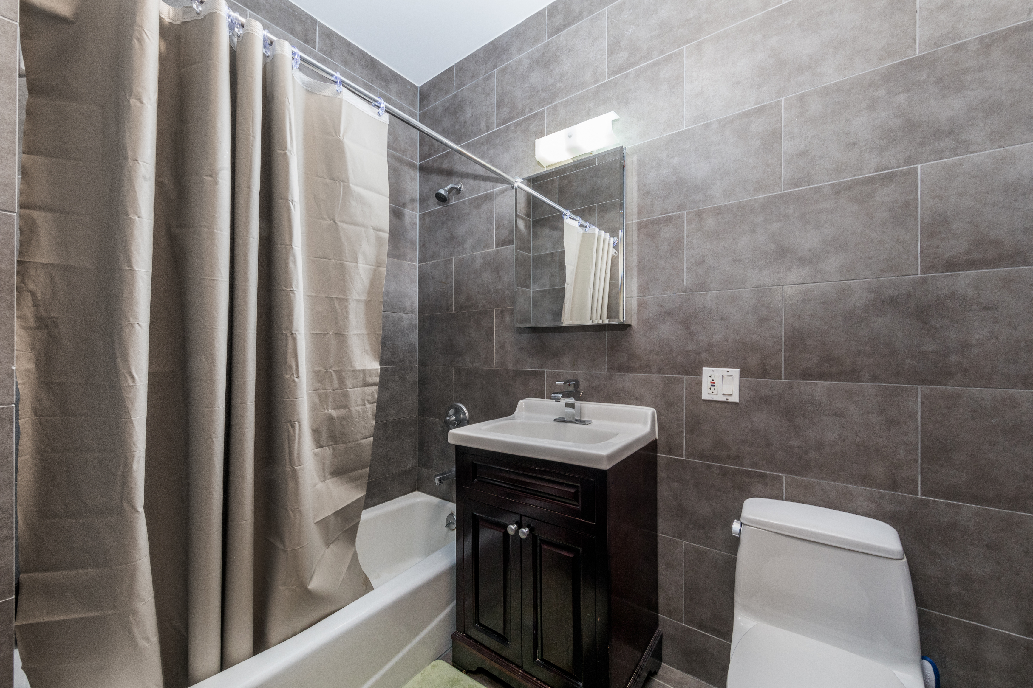 713 Metropolitan Avenue, Unit 2R Brooklyn, NY 11211 - Photo 4 of 5 a bathroom with a sink a toilet and shower