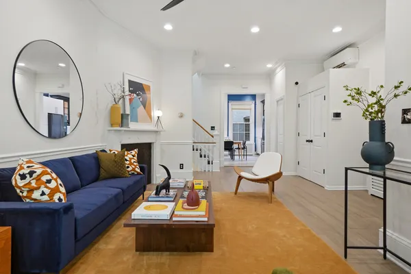 a living room with furniture and a mirror