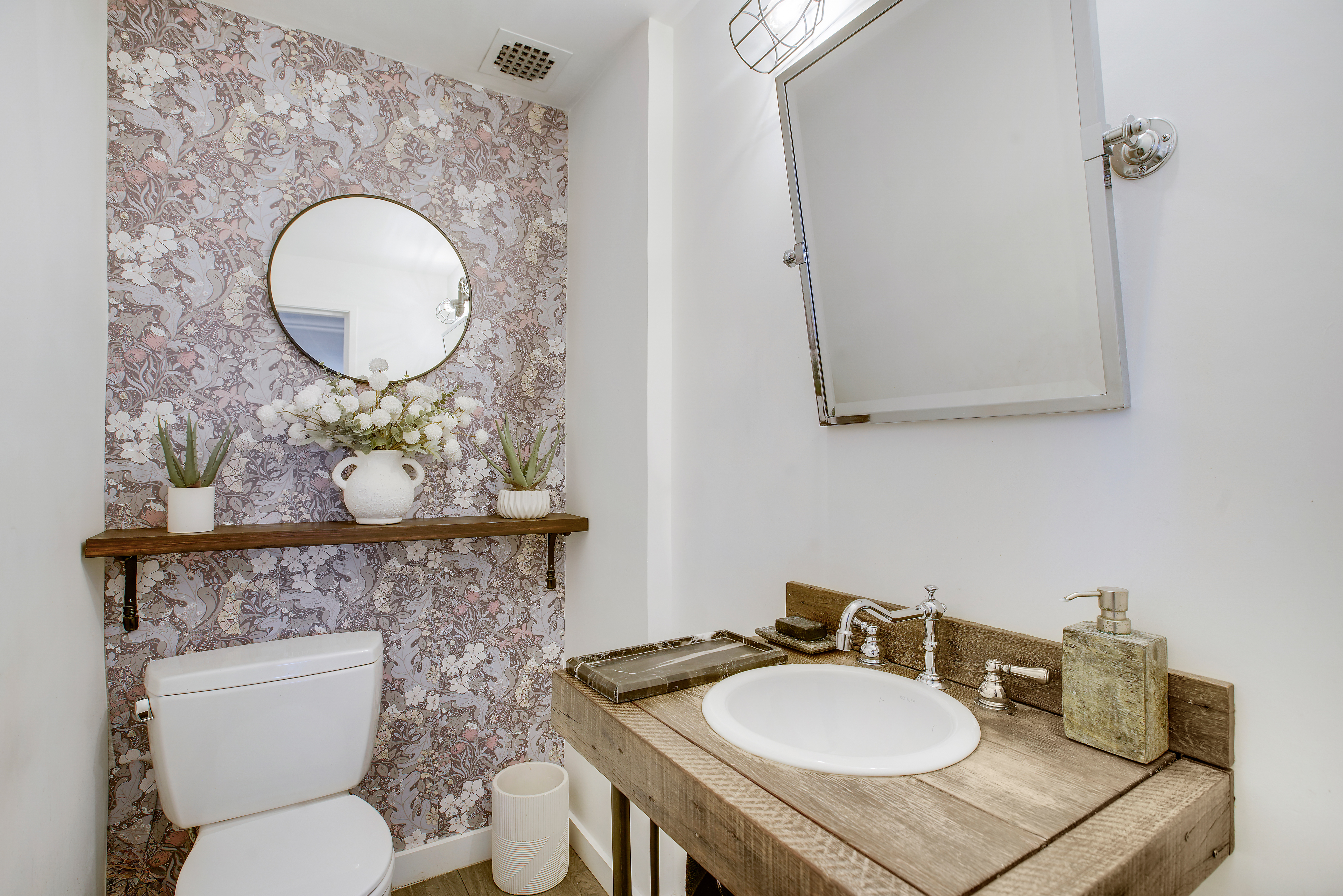 175 East 62nd Street, Unit 18B Manhattan, NY 10065 - Photo 11 of 17 a bathroom with a toilet a sink and a mirror