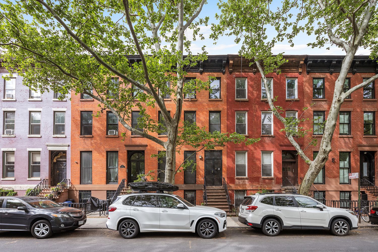 a car parked in front of a brick house