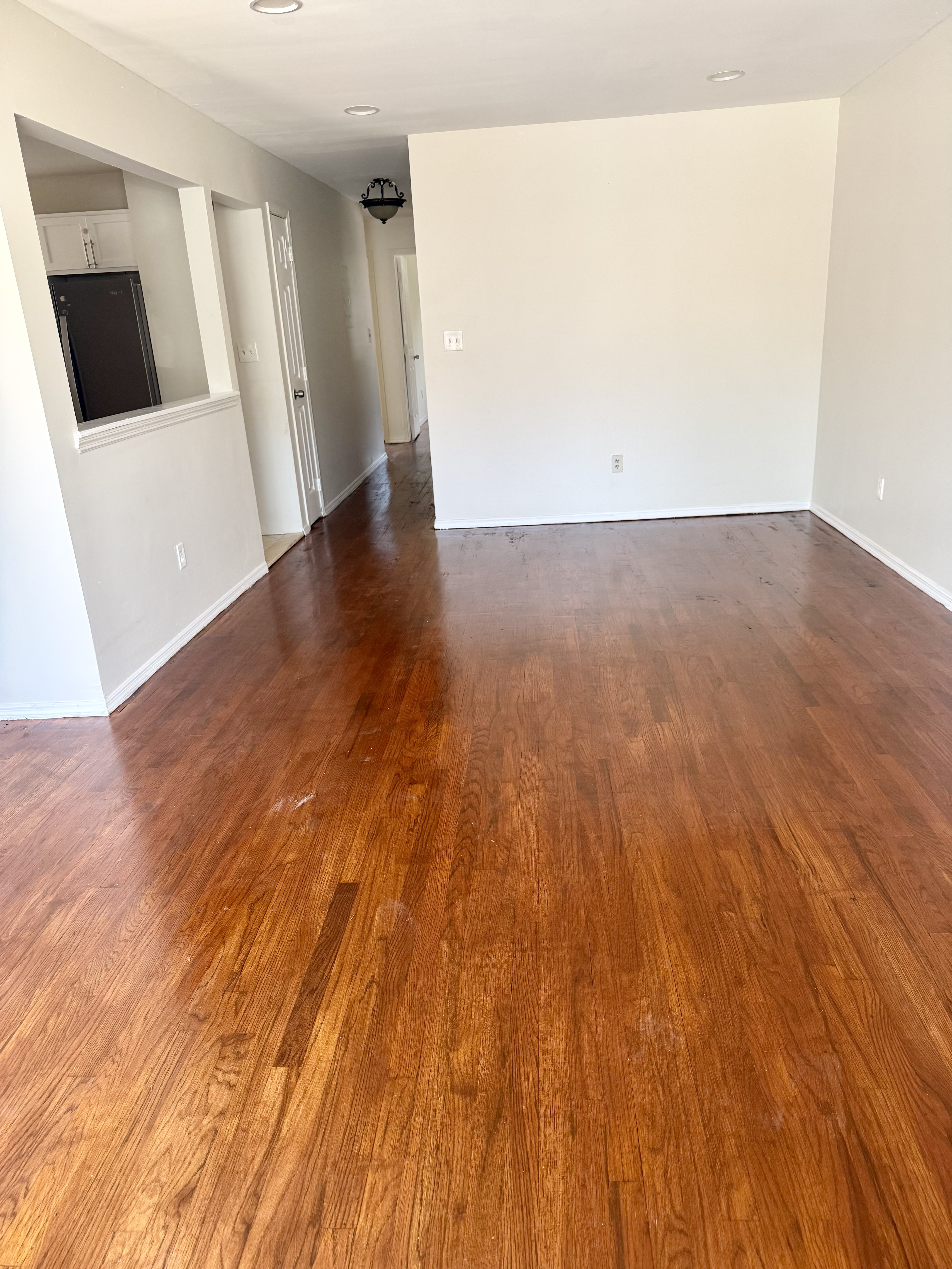 156-17 76th Street, Unit 1 Queens, NY 11414 - Photo 2 of 12 a view of an empty room with wooden floor and a window
