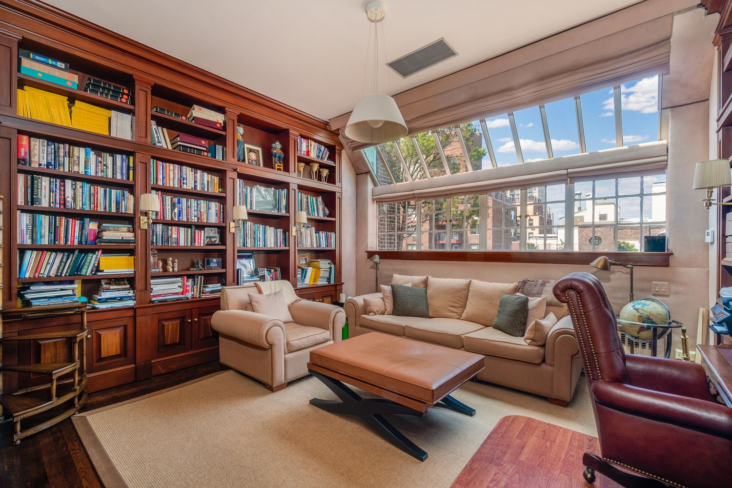 a living room with furniture and a book shelf