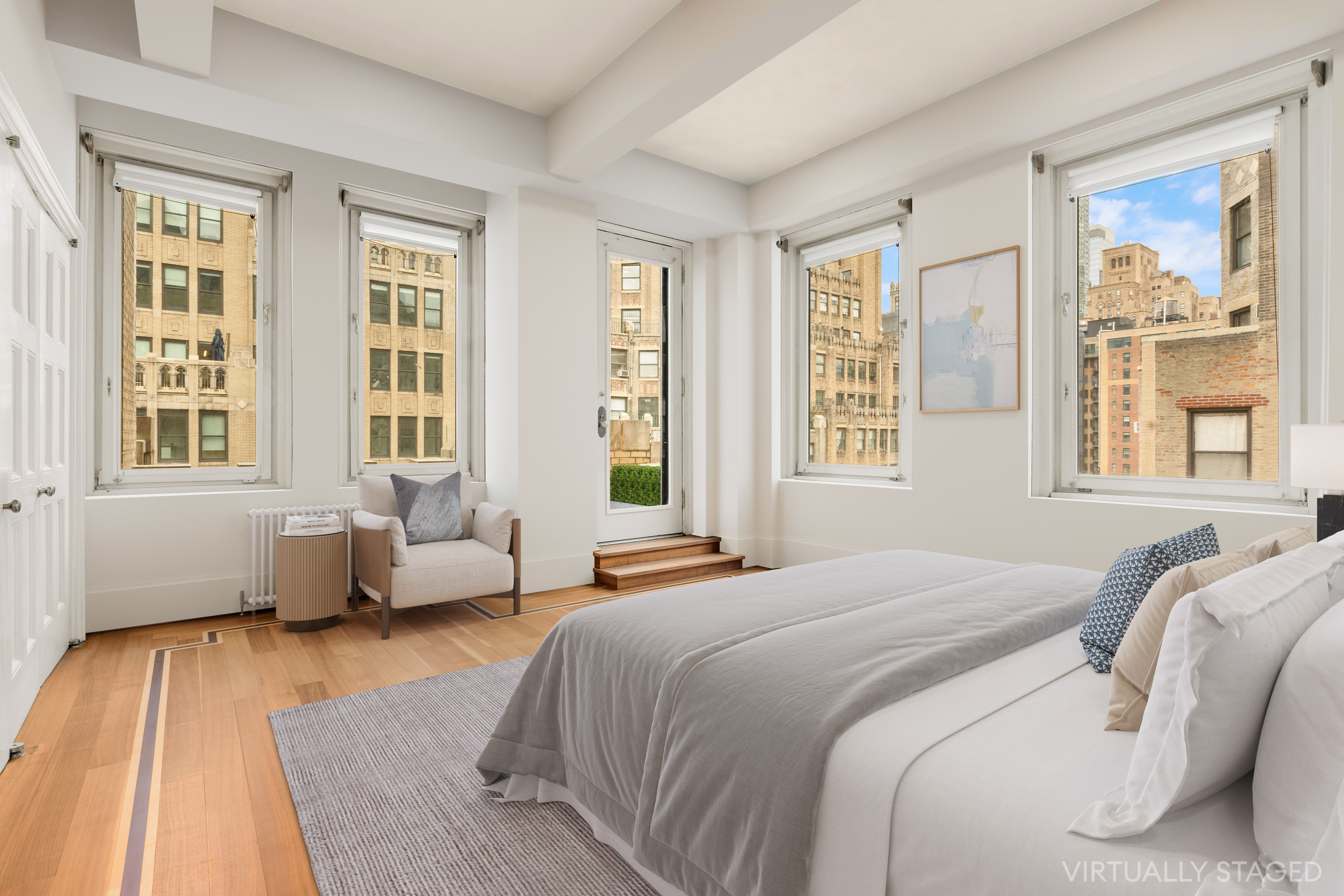 252 West 30th Street, Unit 12 Manhattan, NY 10001 - Photo 13 of 20 a bedroom with a bed and wooden floor