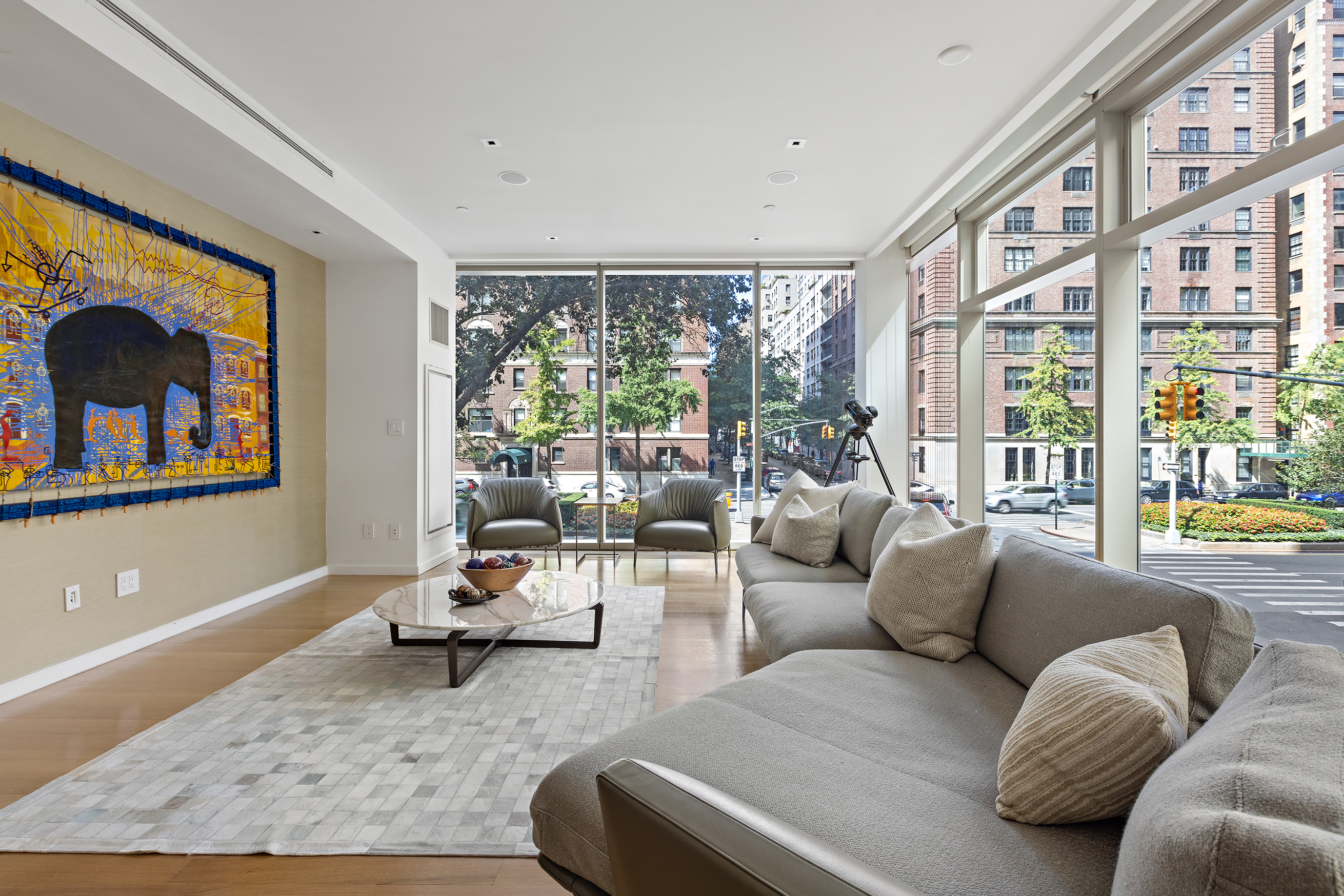 1055 Park Avenue, Unit 1 Manhattan, NY 10028 - Photo 2 of 19 a living room with furniture and a large window