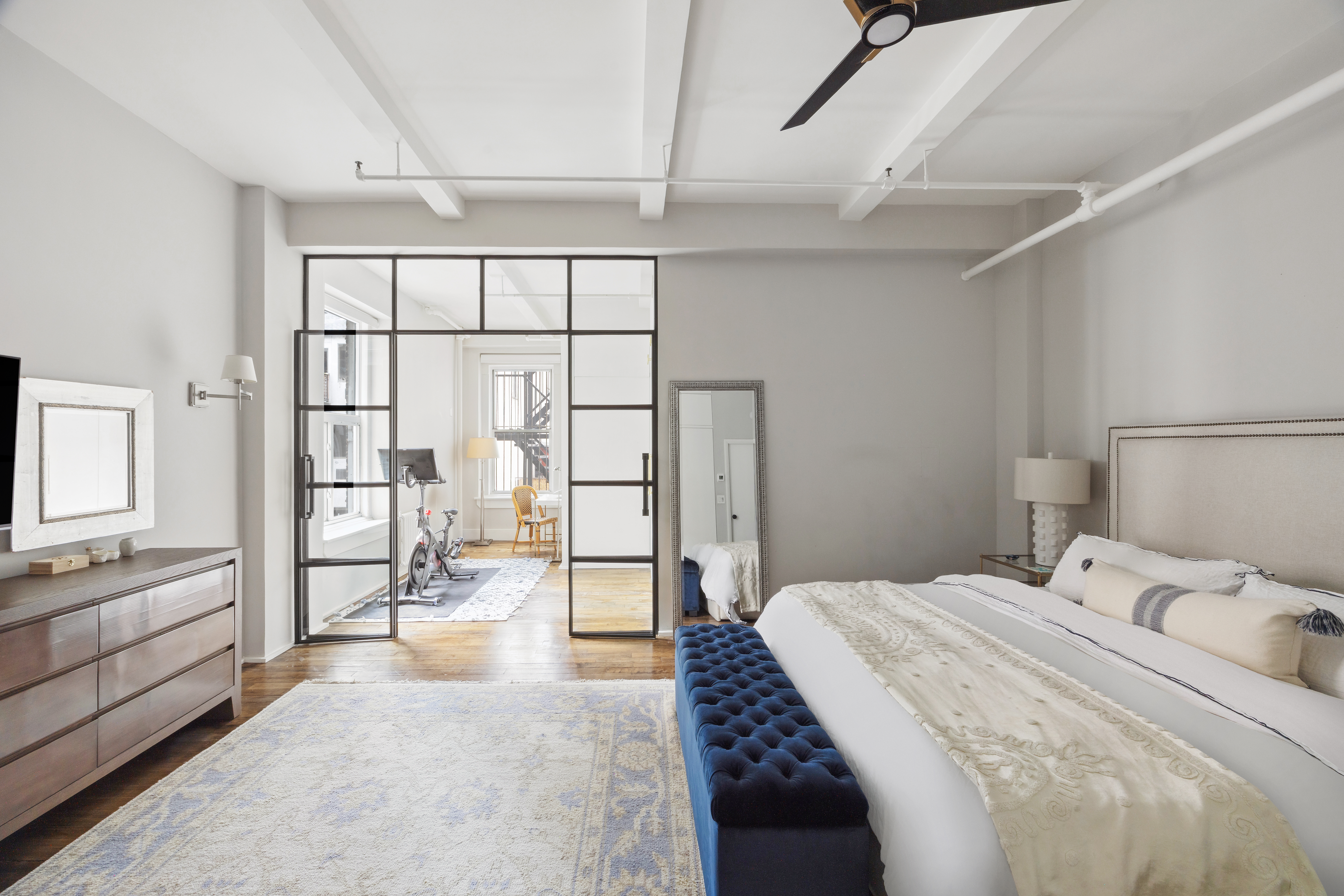 129 West 22nd Street, Unit 5A Manhattan, NY 10011 - Photo 7 of 13 a bedroom with a bed and a large window