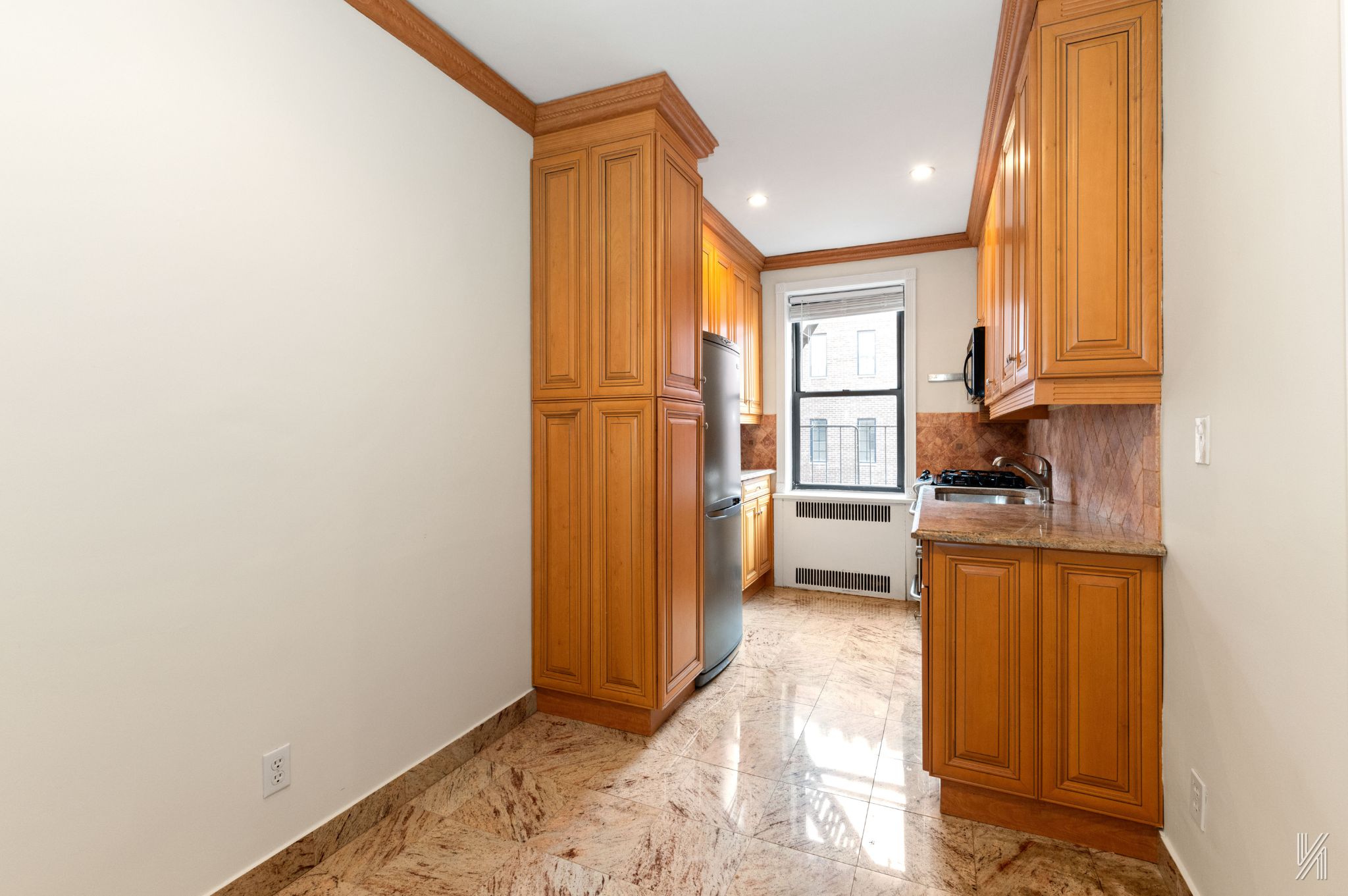 25-40 31st Avenue, Unit 6E Queens, NY 11106 - Photo 8 of 15 a view of a kitchen with a sink and dishwasher