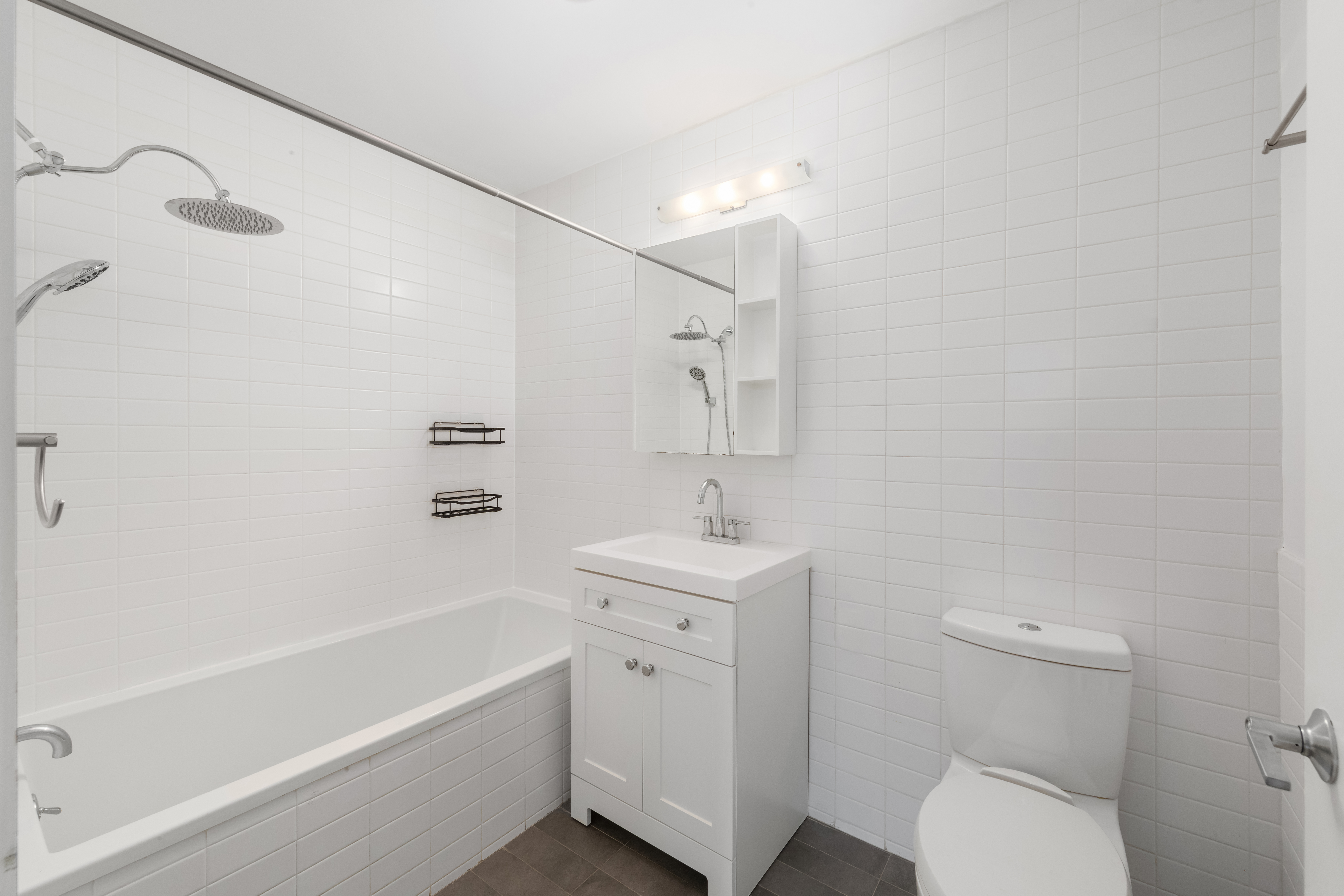 232 7th Street, Unit 3B Brooklyn, NY 11215 - Photo 6 of 7 a bathroom with a sink a toilet and shower