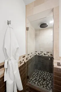 a bathroom with a glass door shower and a sink