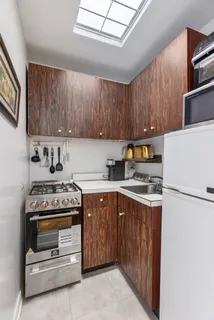 a kitchen with a stove a sink and a refrigerator