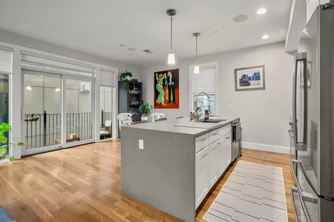 a spacious bathroom with a double vanity sink a large mirror and shower