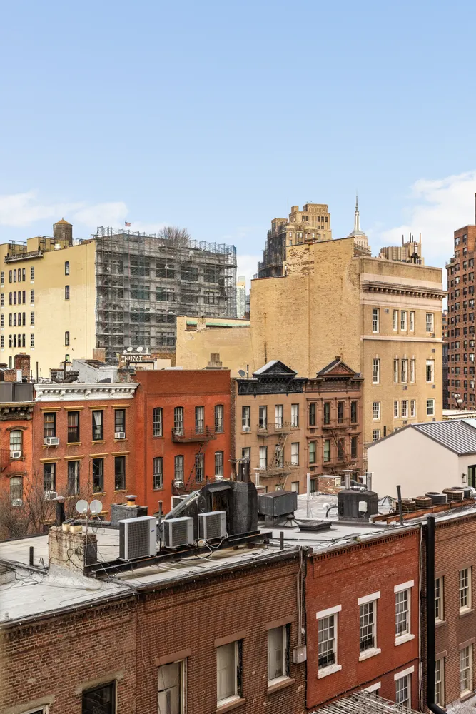 a view of a large building with a city skyline