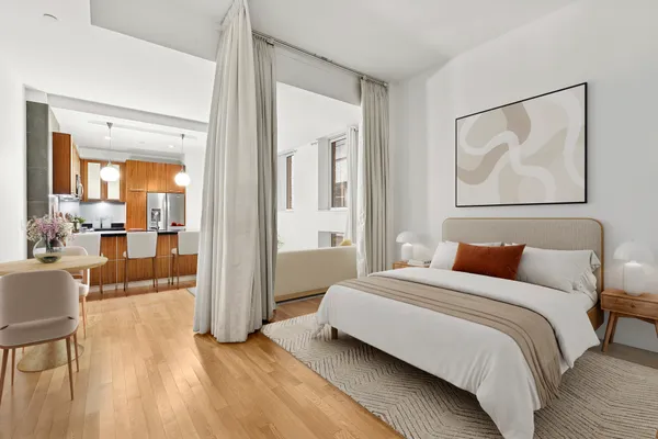 a bedroom with a bed and glass windows