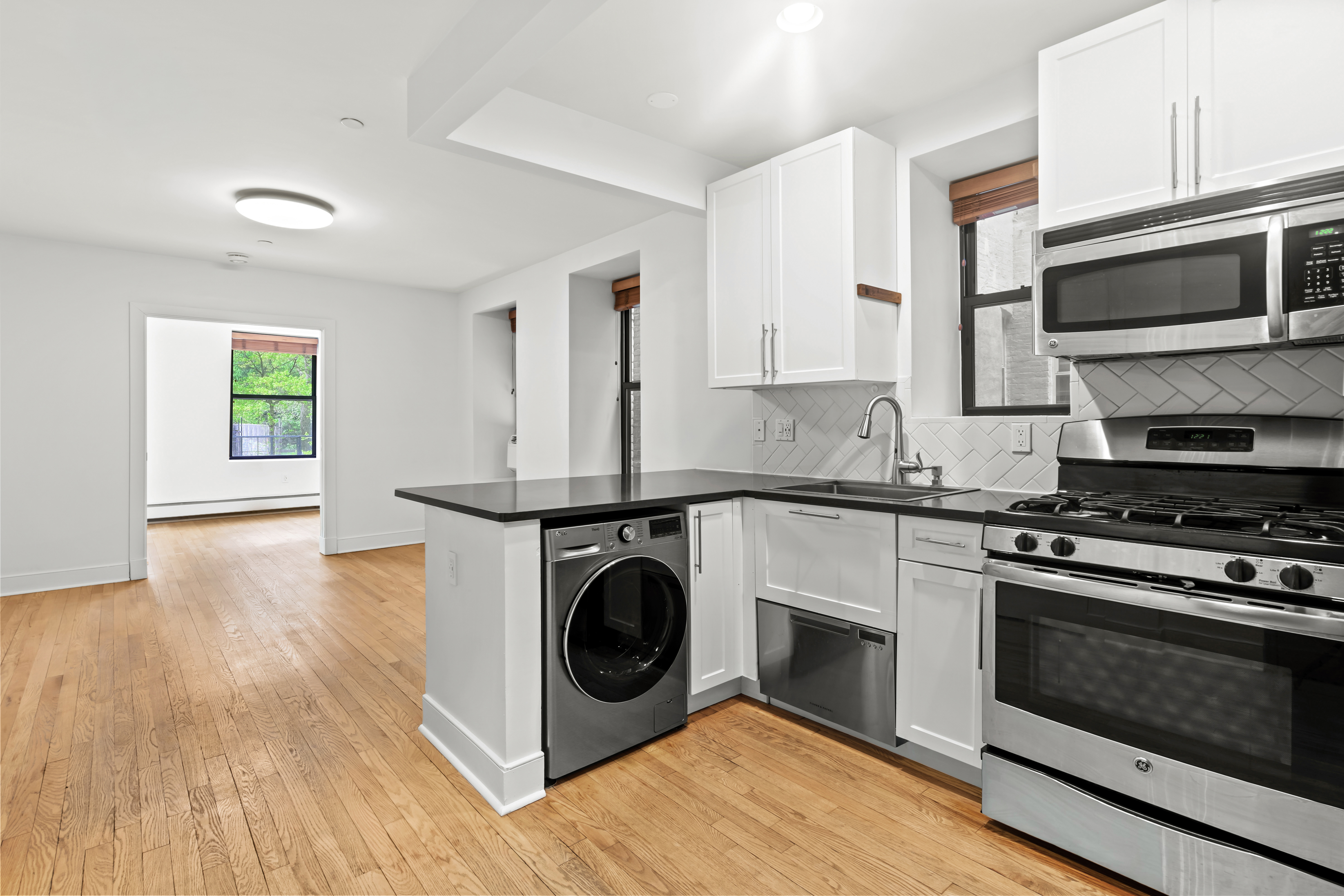 305 West 150th Street, Unit 206 Manhattan, NY 10039 - Photo 4 of 18 a kitchen with a stove and a microwave