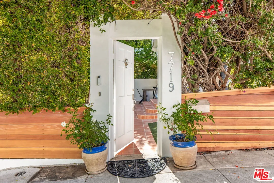 a view of a porch with potted plants