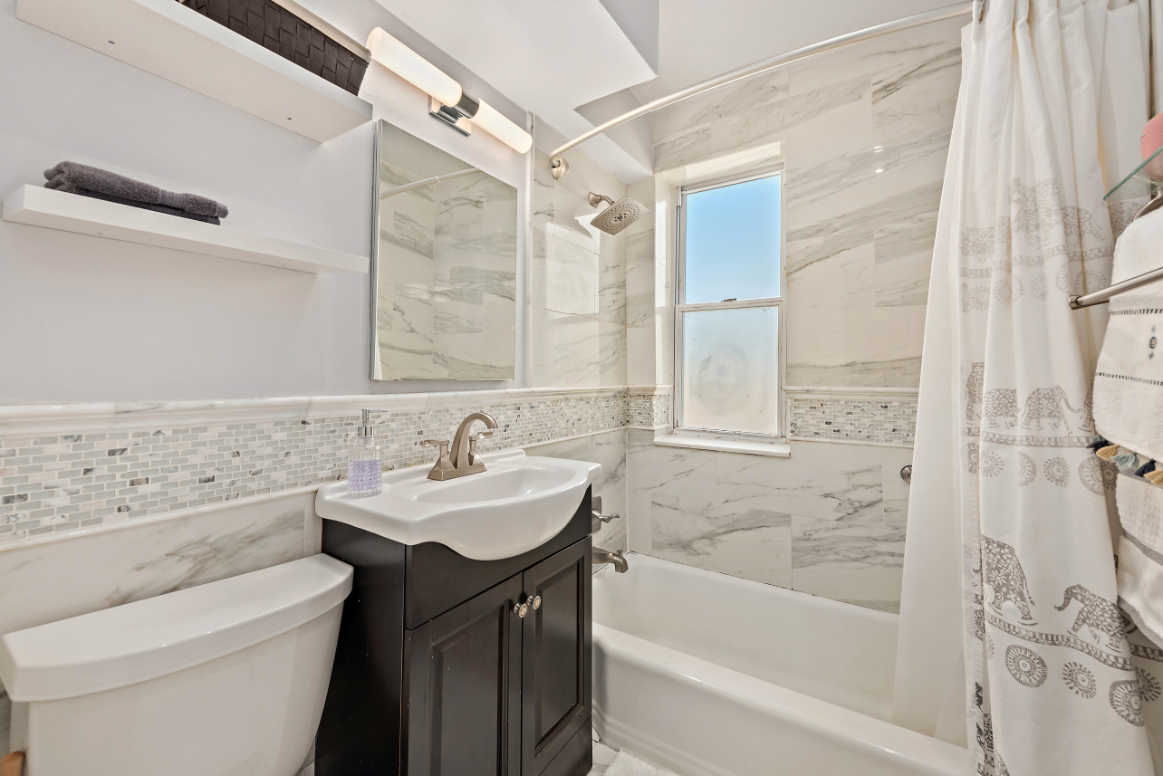 5730 Mosholu Avenue, Unit 4F Bronx, NY 10471 - Photo 12 of 15 a bathroom with a sink a toilet and shower