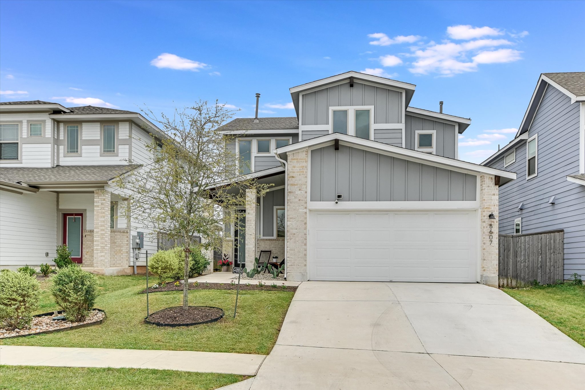 8607 McKamy Drive Austin, TX 78744 - Photo 3 of 28 a view of a white house next to a yard