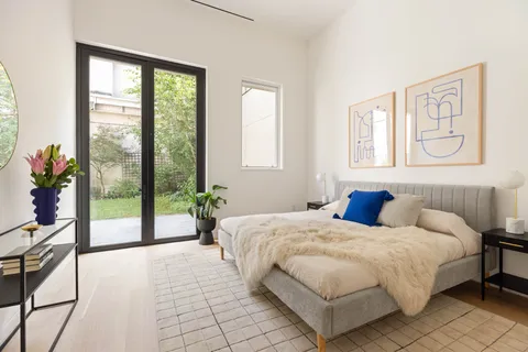 a bedroom with a bed and a large window