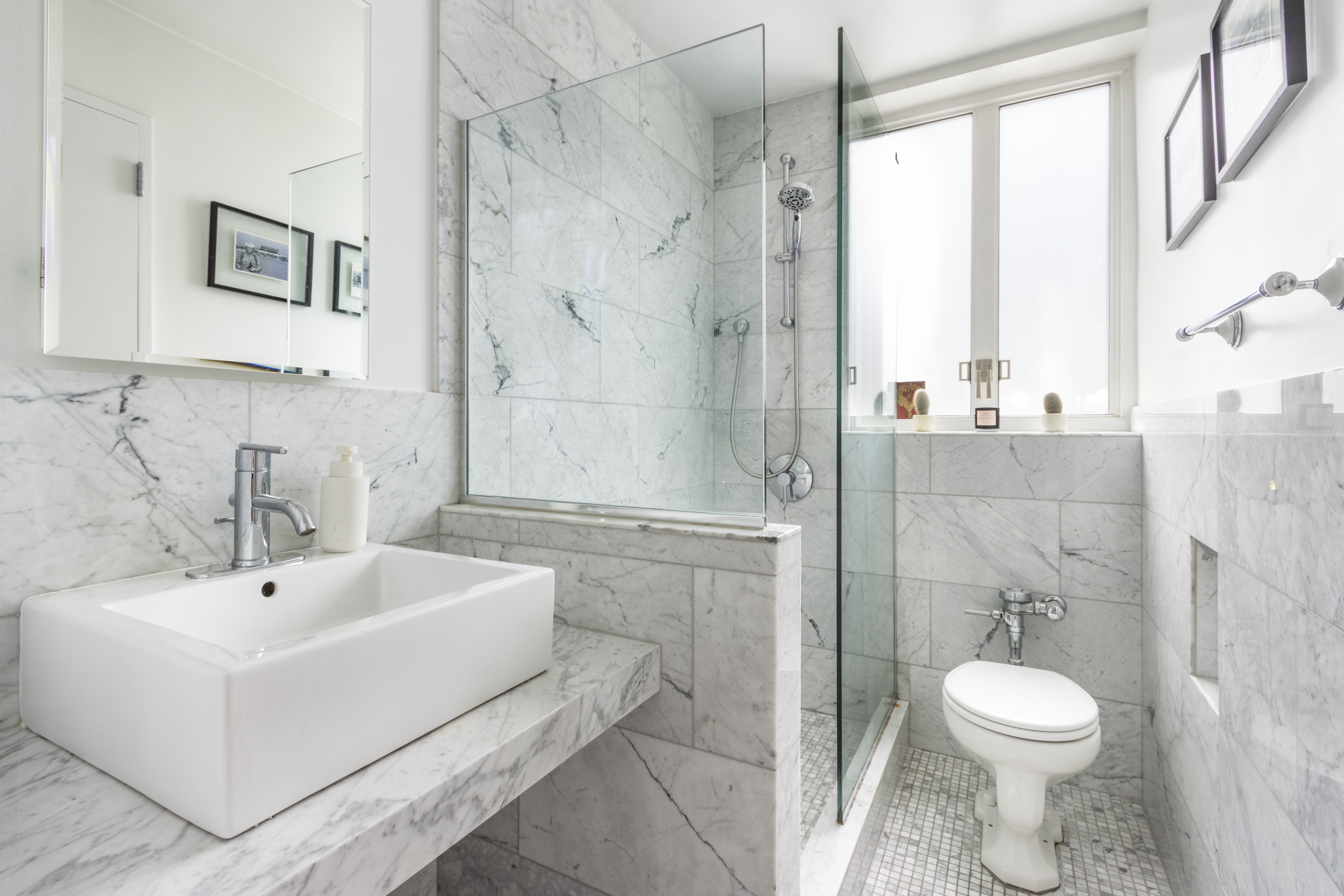200 West 20th Street, Unit 508 Manhattan, NY 10011 - Photo 4 of 6 a bathroom with a sink a toilet and shower