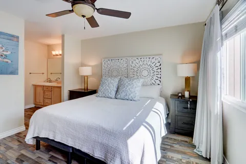 a bedroom with a bed and a chandelier