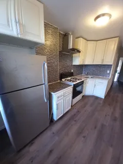 a kitchen with a stove a sink and a refrigerator