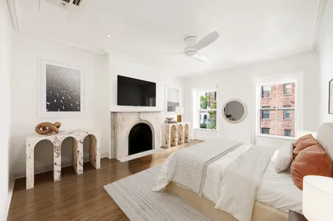 a bedroom with a bed and a fireplace