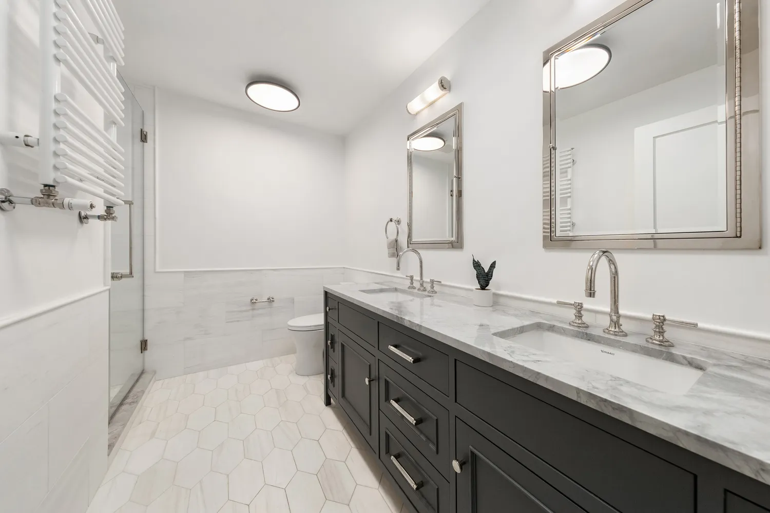 a spacious bathroom with a granite countertop double vanity sink a mirror and a bathtub