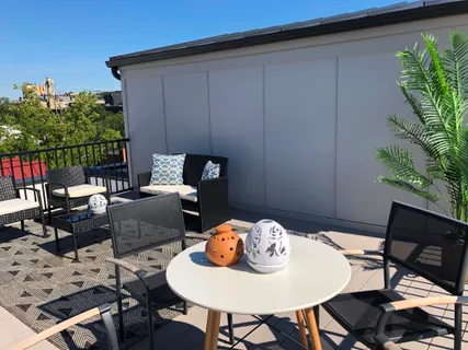 a backyard of a house with table and chairs