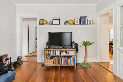 a view of an entryway with wooden floor