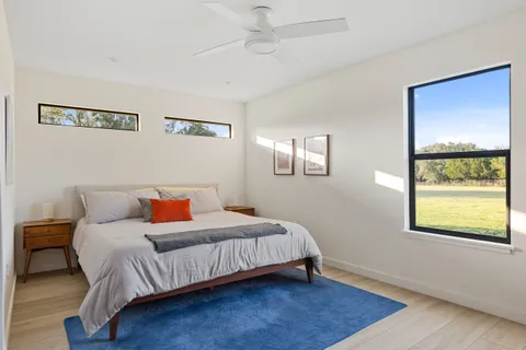 a bedroom with a bed and window