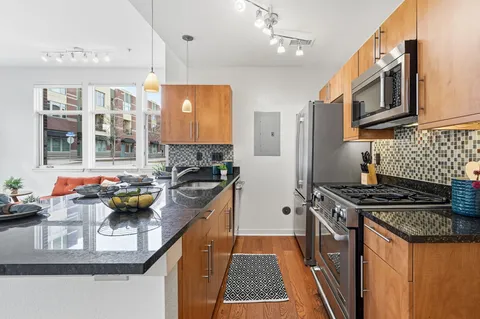 a kitchen with stainless steel appliances granite countertop a stove and a sink