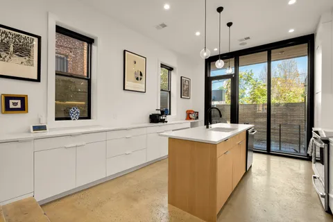 a kitchen with stainless steel appliances granite countertop a sink and a stove