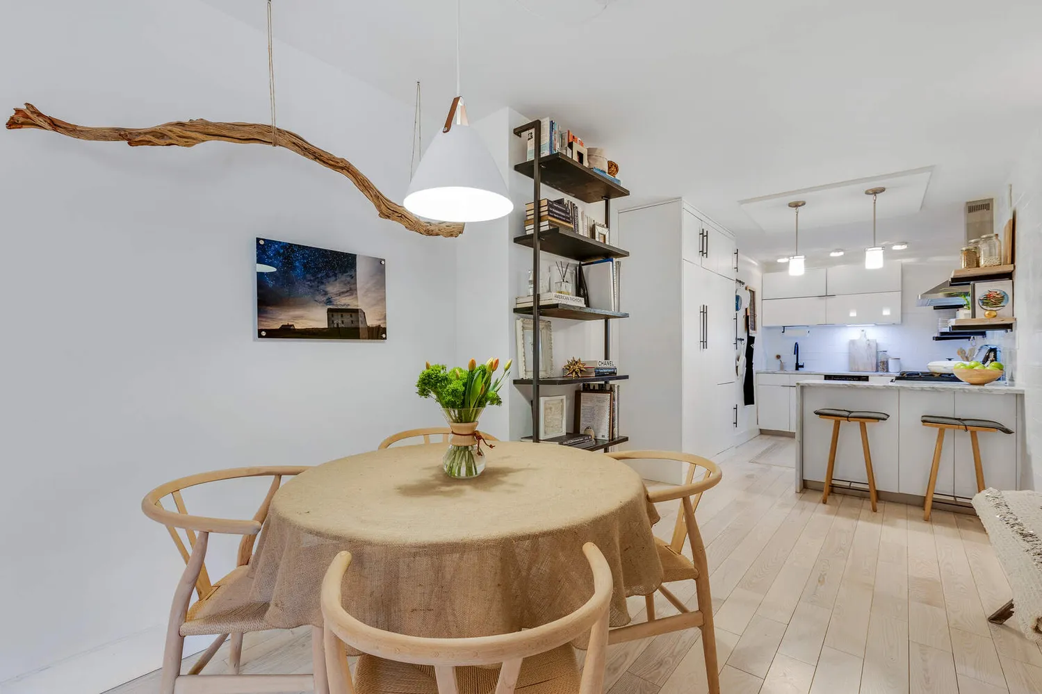 a kitchen with a dining table chairs and a chandelier