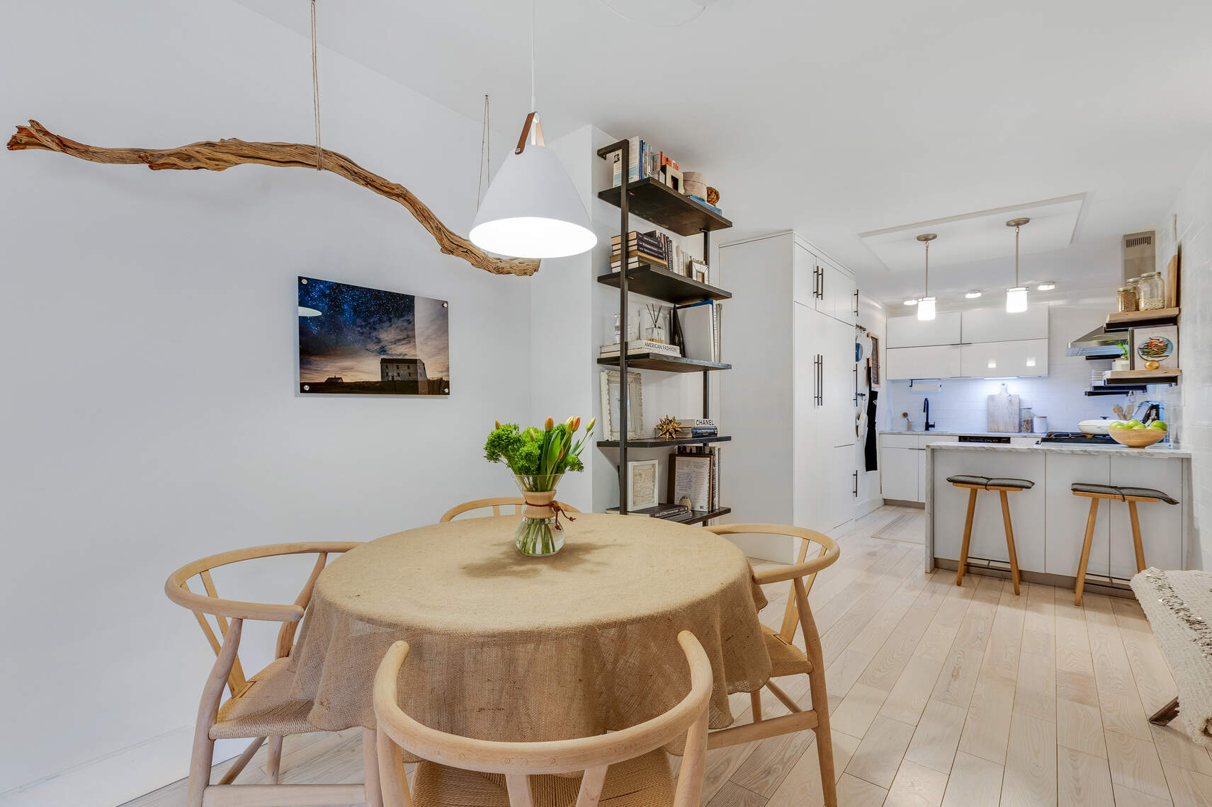 201 East 21st Street, Unit 4M Manhattan, NY 10010 - Photo 6 of 11 a kitchen with a dining table chairs and a chandelier