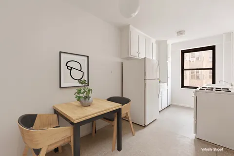a living room with stainless steel appliances furniture a refrigerator and a window